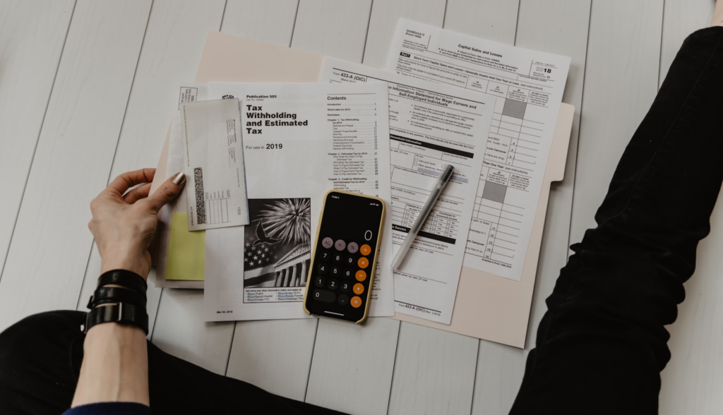 Reviewing personal tax documents with a calculator