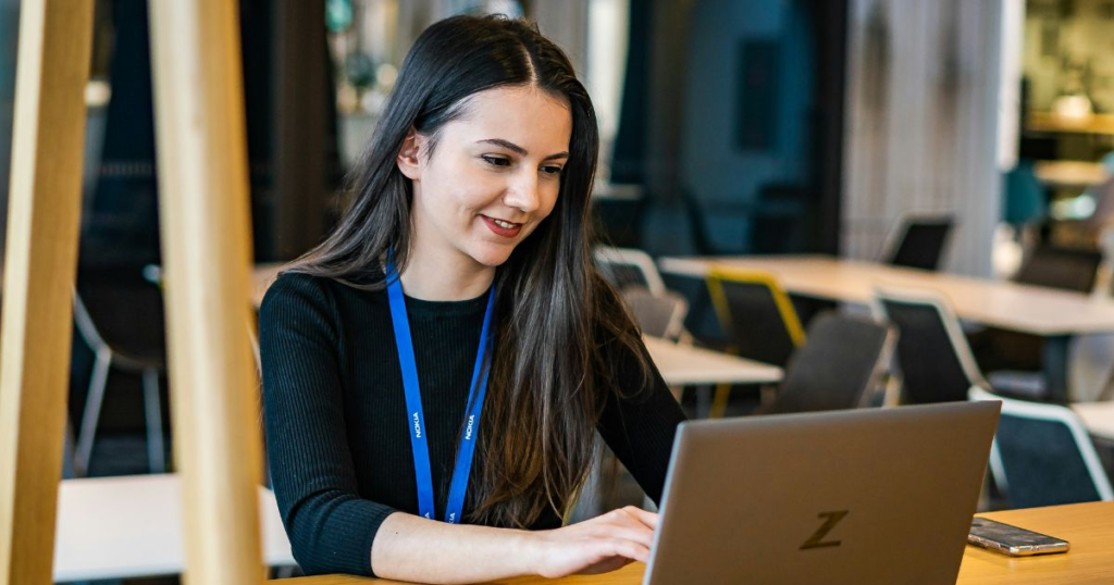 Woman working on laptop in cafe