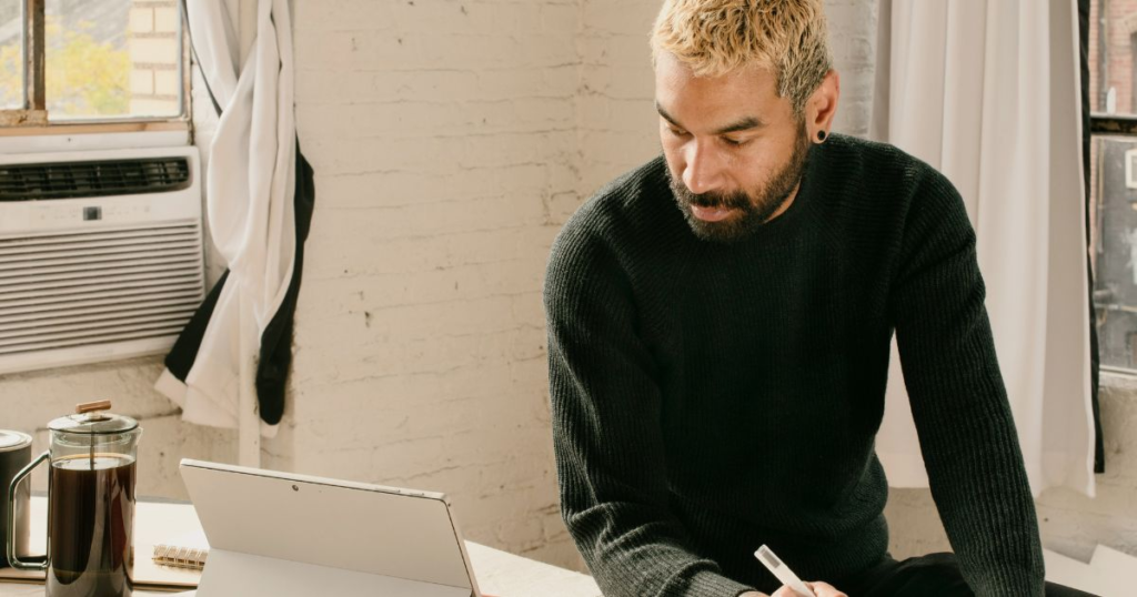 Man working on tablet in room