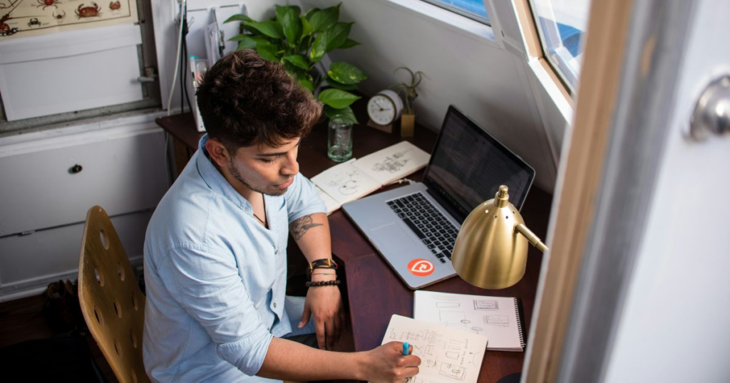 Person working at a desk, sketching.