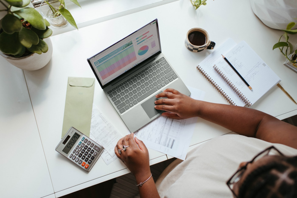 Small business owner reviewing monthly bookkeeping records on a laptop in a Toronto office