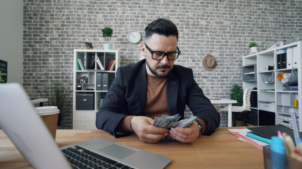 Small business owner reviewing finances on a laptop with an accountant in the Greater Toronto Area