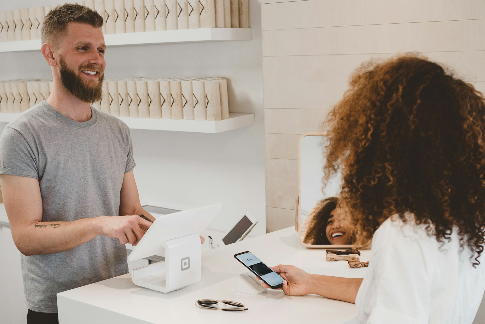 Small business owner in Scarborough taking a contactless payment at the counter